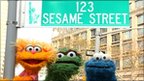 Sesame Street characters pose under a "123 Sesame Street" sign, November 2009 in New York City